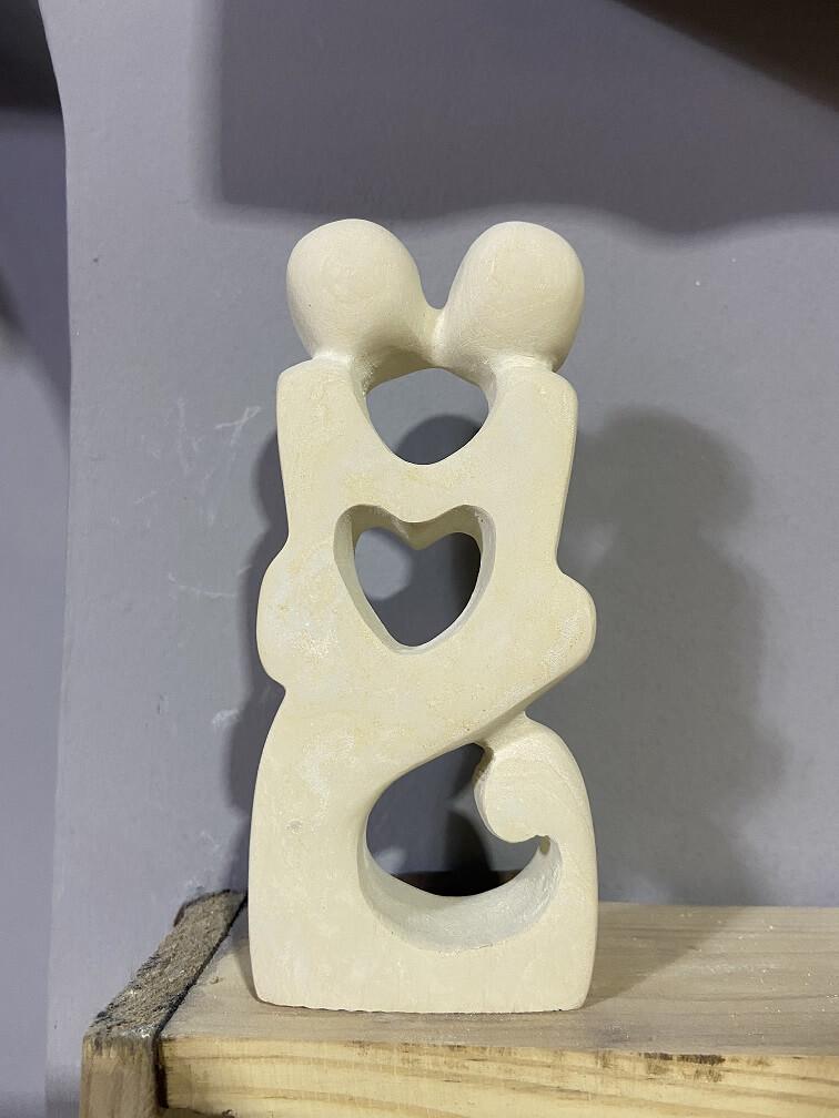 Sculpture couple kissing in limestone